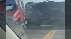 Video shows freight train slamming into stalled semi-truck in Melbourne; driver escapes unharmed